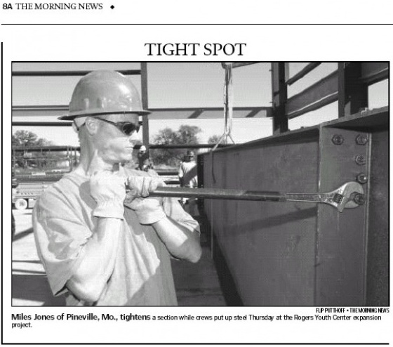 Founder Miles Jones erecting steel on a Northwest Arkansas job site